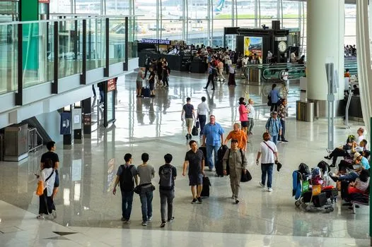 airport security checkpoint with trays scanner and passengers waiting in line