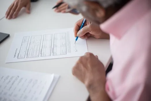 court application preparation scene with lease contract, certified copy checklist, ID card cover, and pen on neutral desk, Korean housing issue editorial photo