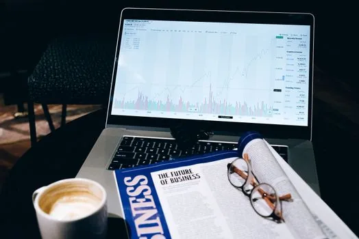 Korean investor reviewing a printed ETF new listing table beside laptop stock chart and calendar, bright finance newsroom photo, no readable brand logos | 신규 ETF 상장 일정을 확인하는 장면 | 9월 1일 상장 일정 설명용 이미지