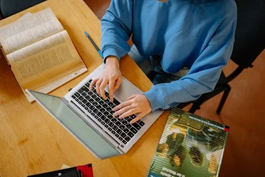 Korean student preparing CSAT application online pre entry with laptop, ID photo file, calendar and school documents on desk, bright editorial education photo, no real logos | 수능 원서접수 온라인 사전입력 준비 이미지