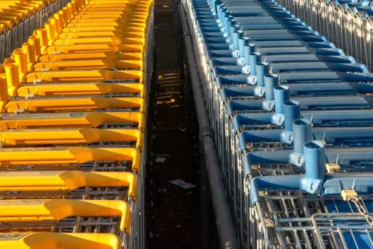 Korean supermarket entrance with shopping carts and bright morning light