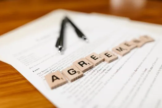 Korean tenant arranging lease contract copy resident registration extract and registry certificate on desk | 전세사기 피해자 결정 신청 전 서류를 정리하는 장면