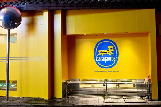 nighttime Wolmido amusement park entrance with soft police and ambulance presence, editorial Korean news style, no injury scene, no readable brand signs
