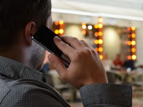 person receiving official emergency link message on smartphone after calling 112, blurred home hallway background, location pin icon concept, calm safety guide mood