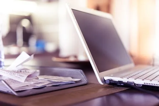 checklist of employment screening documents with laptop login and identity card on neutral Korean office desk, realistic editorial photo