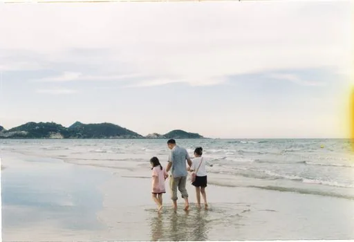 family visitors checking sea skywalk entrance time on smartphone near Gangwon coast, late afternoon light, no readable logos