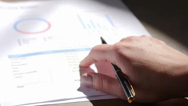 Korean adult sorting privacy breach notice, bank transfer receipt and police report copy on a clean desk, realistic photo, no readable personal information | 유출 통지와 피해 입증자료를 날짜순으로 정리하는 장면
