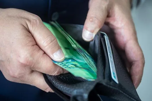 Korean driver checking empty wallet and identity card at bright desk after losing driver license, editorial photography no text | 운전면허증 분실 뒤 신분증과 지갑을 확인하는 장면