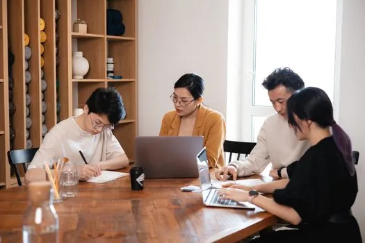 Korean middle aged professional checking project contract checklist, pen, calendar, laptop, no readable personal data | 프로젝트 계약 전 조건을 점검하는 장면