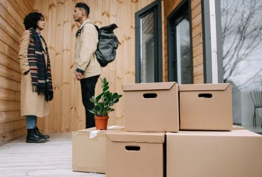 moving day desk with laptop, lease contract, address memo, identification card holder, boxes in background, realistic Korean editorial photo