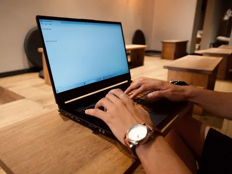person switching from public Wi-Fi to mobile hotspot before online banking on laptop, bright cafe table, no bank logos or personal data | 민감한 로그인 전 모바일 데이터로 바꾸는 장면