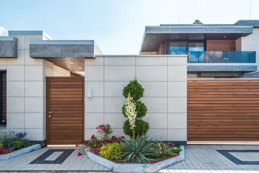 residential alley CCTV camera facing a detached house gate, privacy and trespass news context, photorealistic editorial image