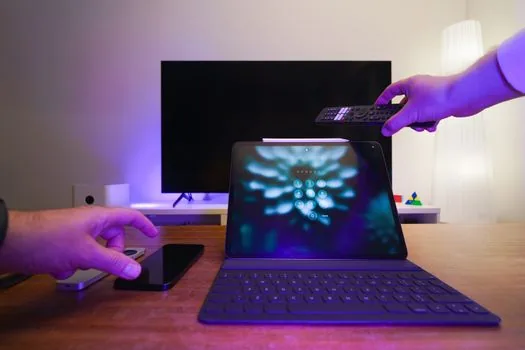 smartphone and laptop showing generic account security checklist with lock icon, bright editorial tech scene, no real logos, no readable credentials