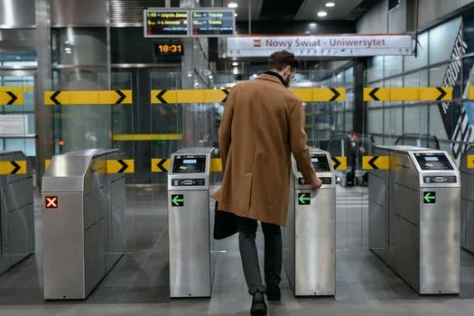 traveler comparing KTX and SRT mobile tickets with separate train numbers and arrival times on a clean desk, station timetable blurred in background, realistic editorial photo | KTX와 SRT 승차권 정보를 따로 확인하는 장면