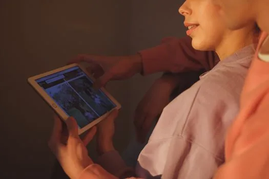 viewer watching Korean period drama on tablet with comment notes beside screen, no recognizable actor, warm living room editorial photo | 시대극 시청 반응을 정리하는 장면