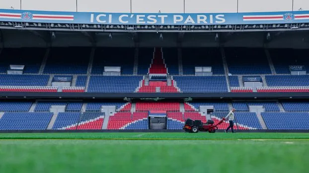 wide editorial photograph of night football stadium stands and scoreboard after France Italy draw, no text